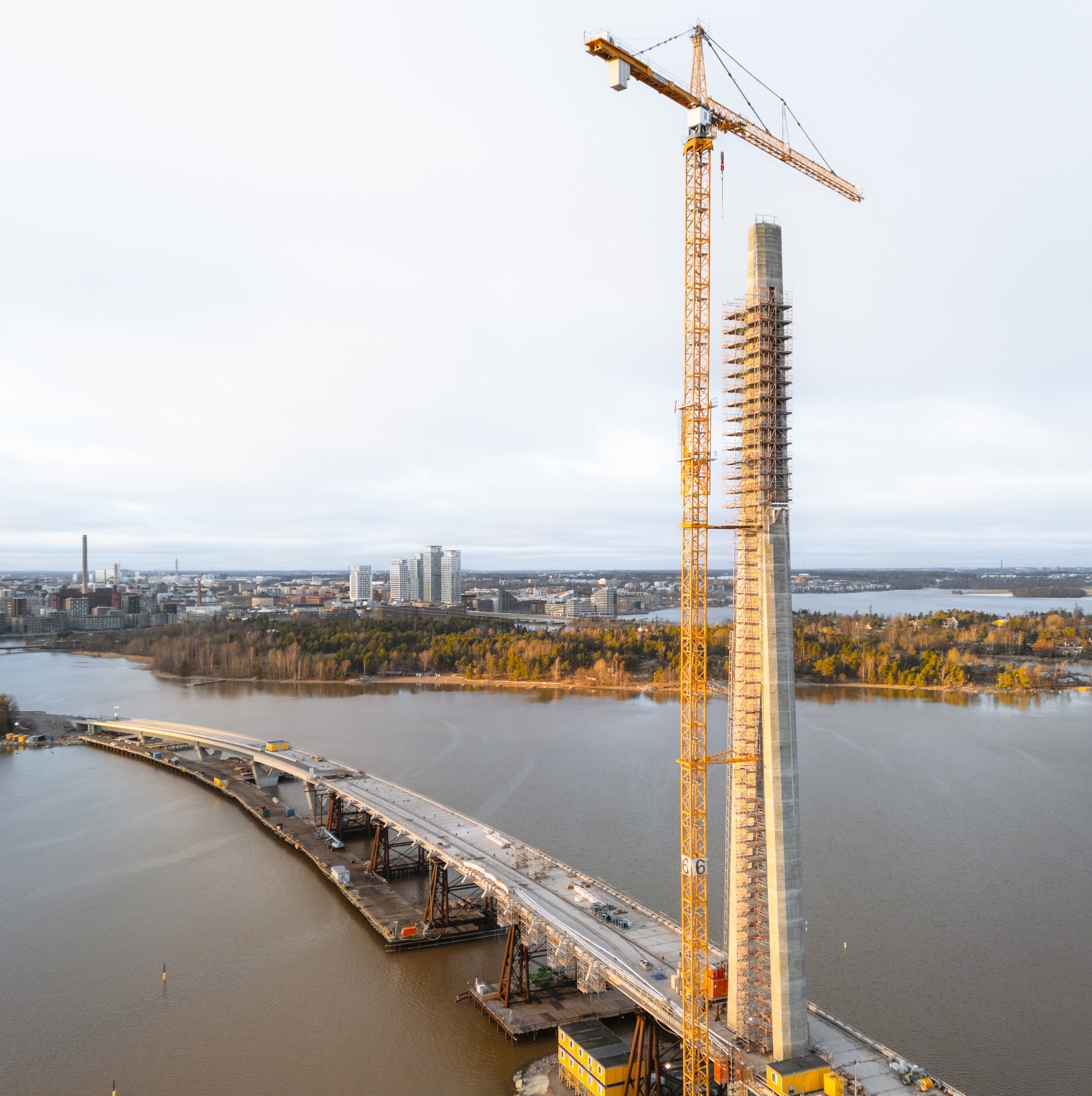 Aerial view of a bridge pylon under construction with crane