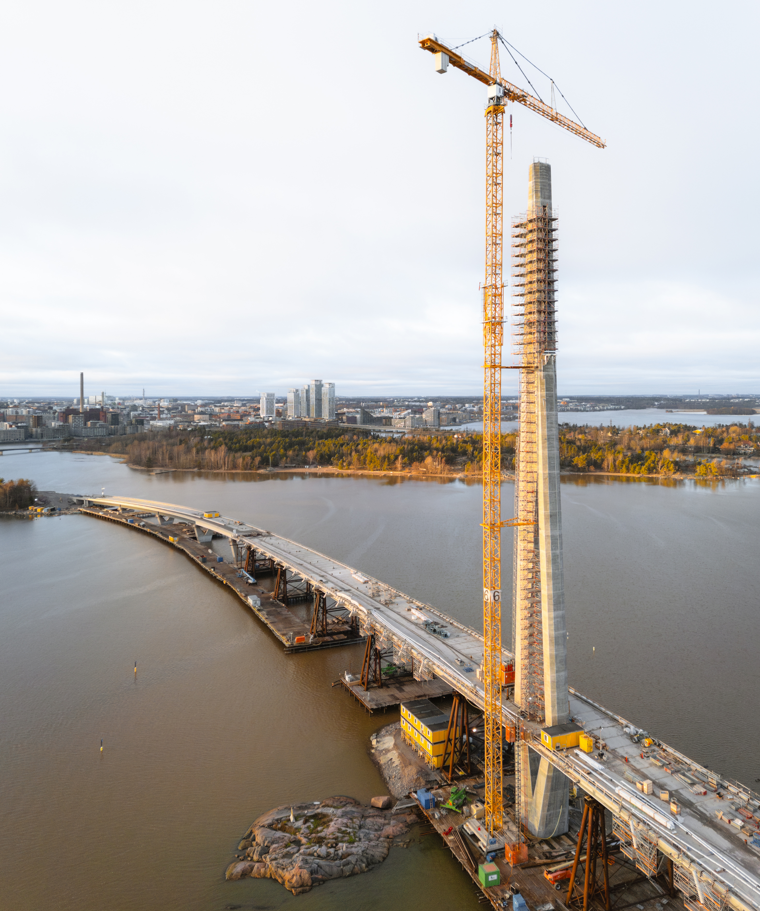 Aerial view of a bridge pylon under construction with crane