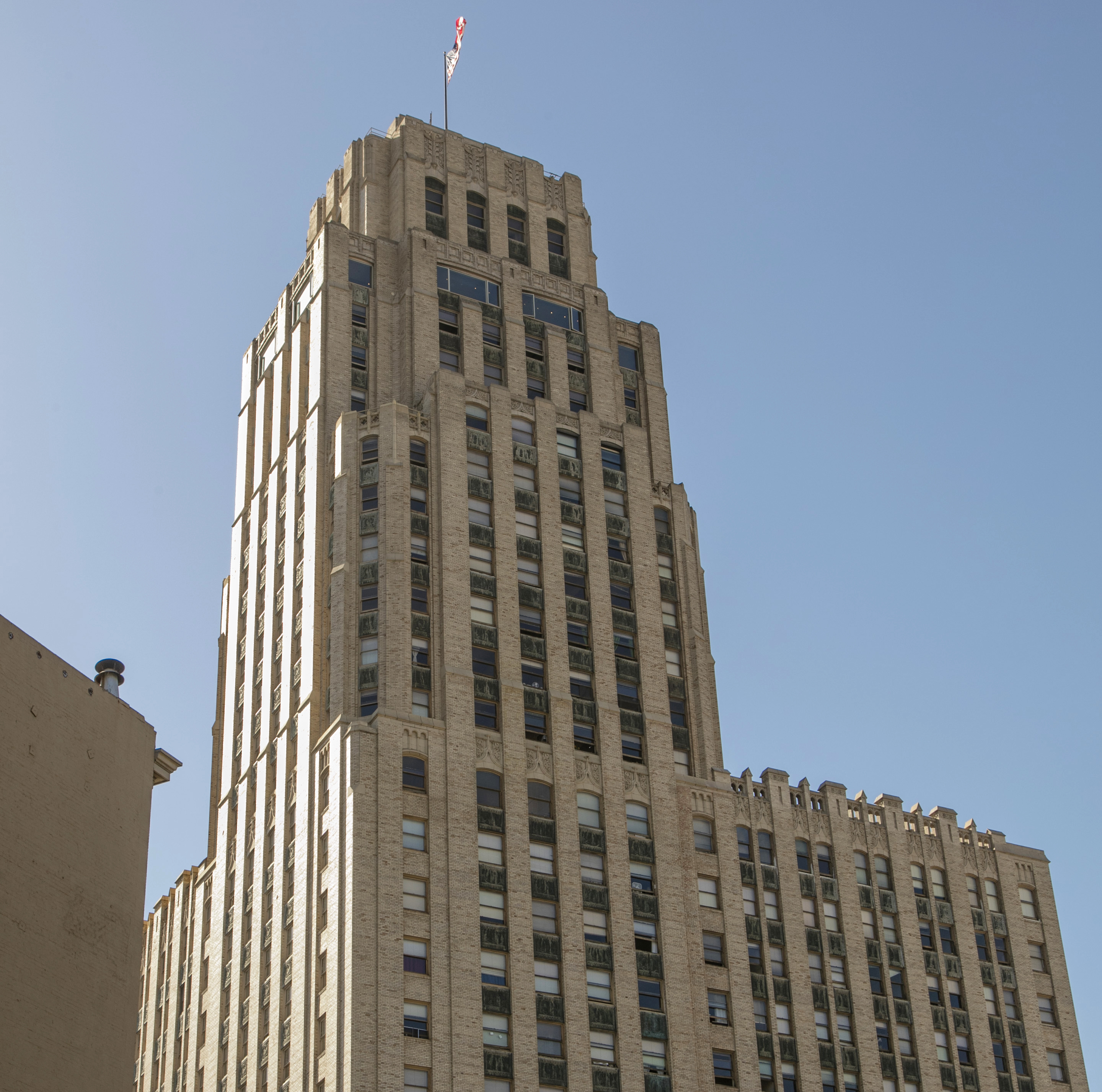 Tall office building seen from below on city street