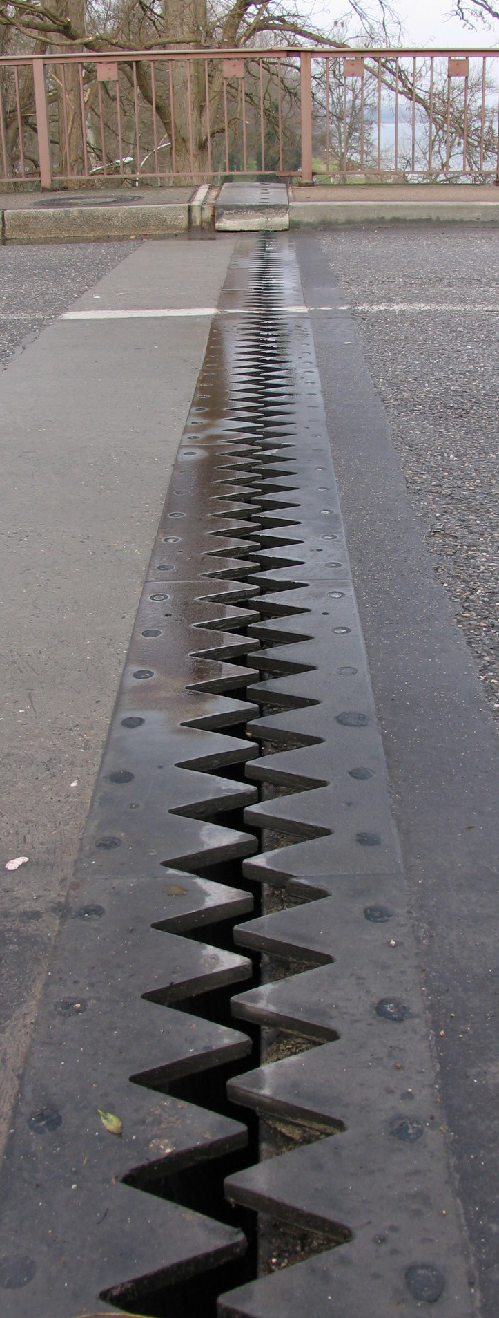 Bridge expansion joint allowing temperature‑driven movement, illustrating climate stresses on infrastructure