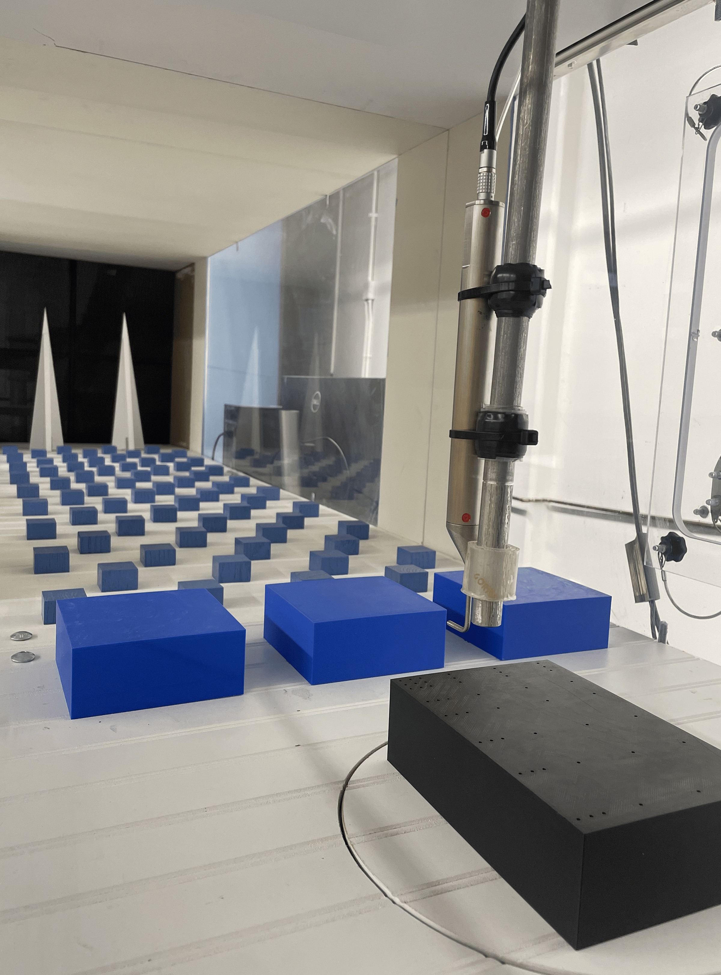 Wind tunnel instrument measures airflow over scaled buildings in hurricane simulation