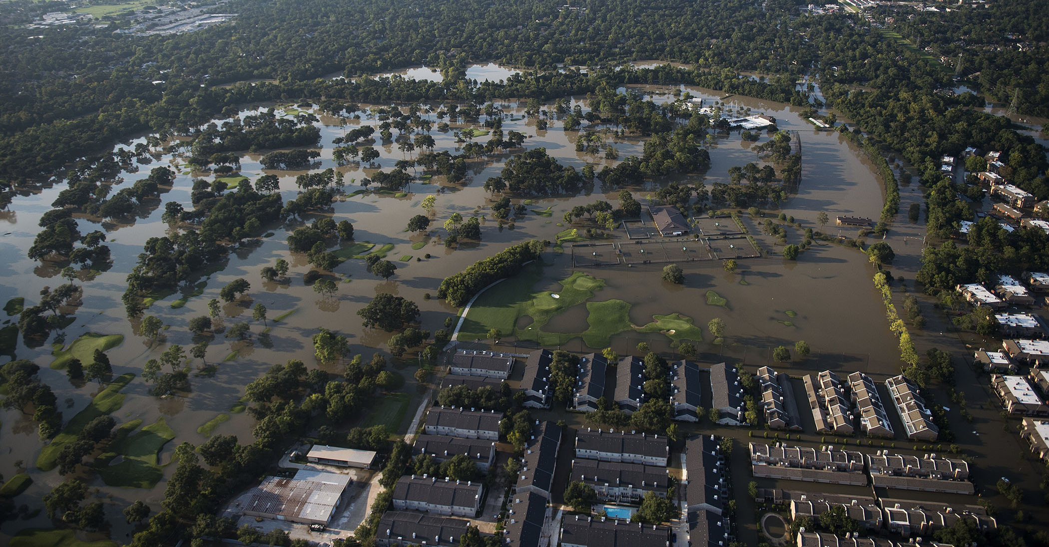 Aerial view of widespread Houston flooding submerging homes, roads, and green space
