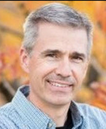 man smiles for the camera