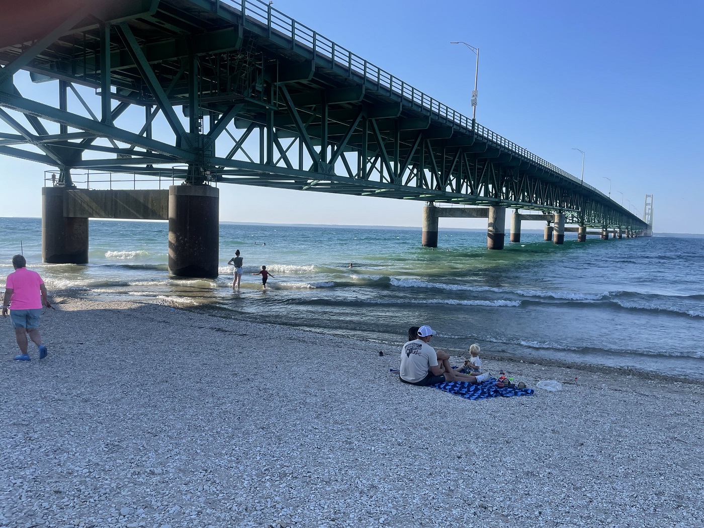 photo of a beach under a bridge