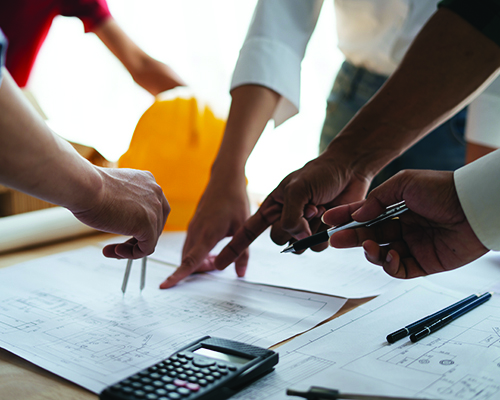 Hands pointing at and considering a document 