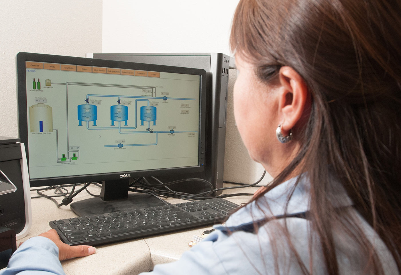 Operator monitors water treatment system on a computer screen