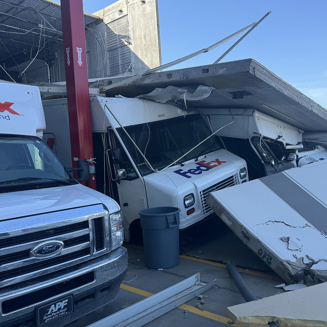 Collapsed wall panel and debris inside tornado-damaged FedEx warehouse